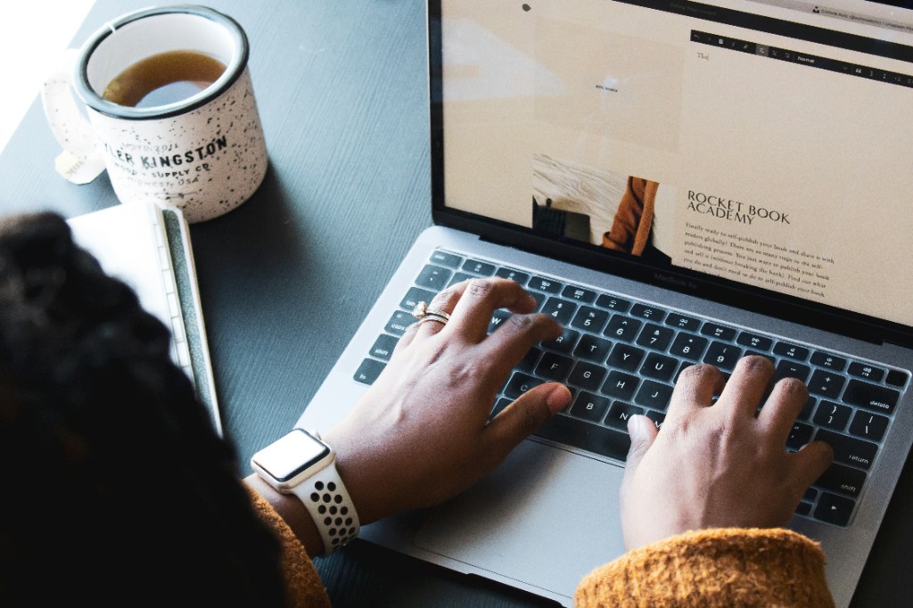 Person typing on a laptop, editing a website—moving from a page builder to code you own